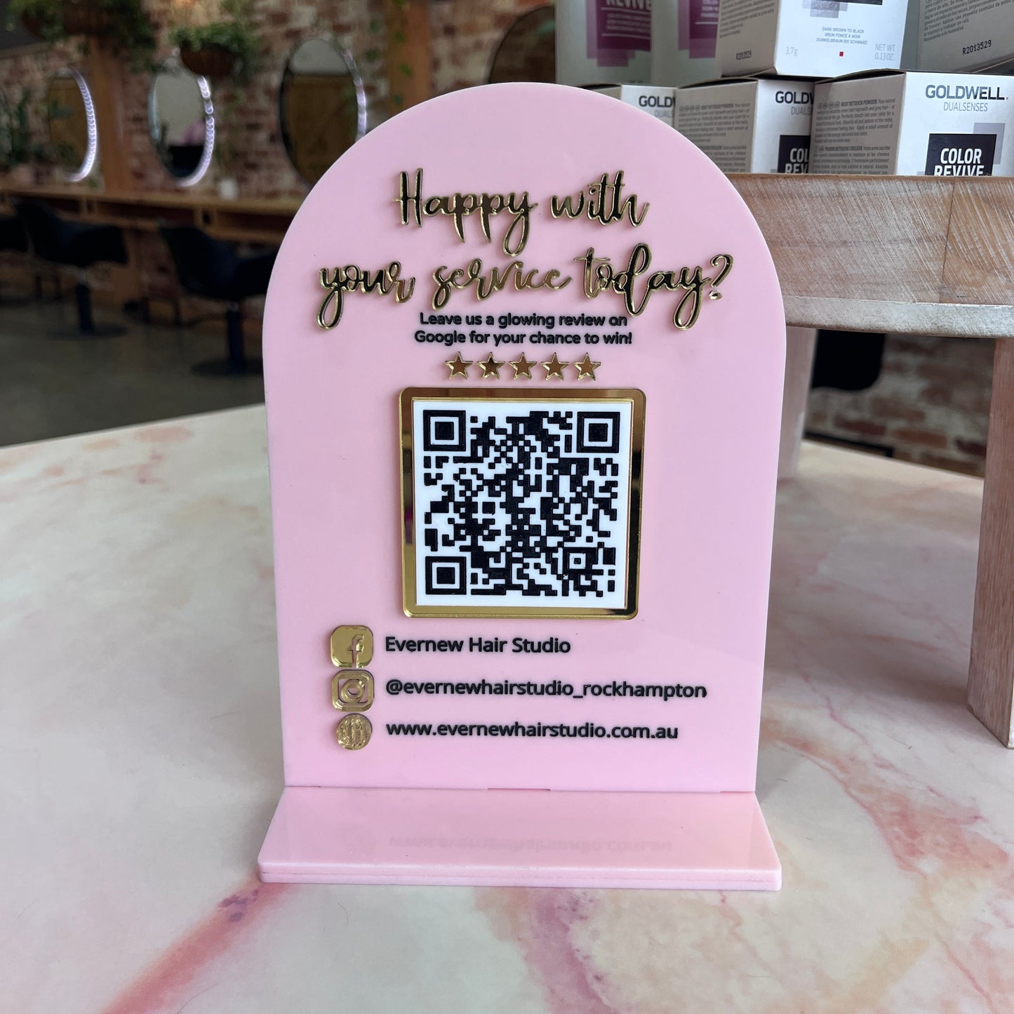 Pink card with QR code and text on a blurred background